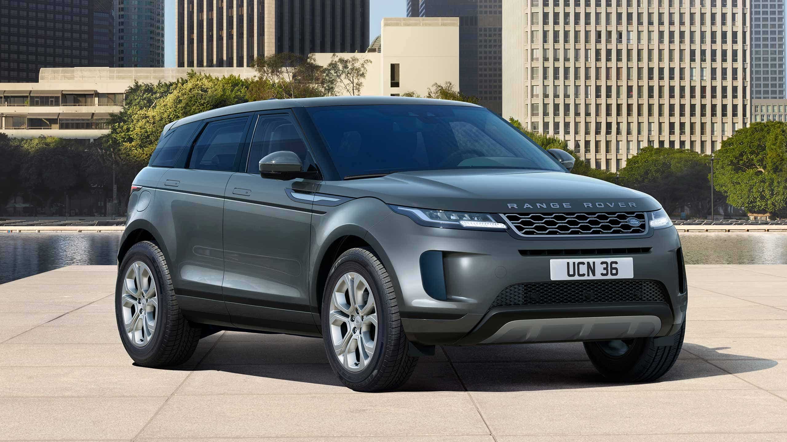 Evoque Parked By Garden Area Against Buildings In City