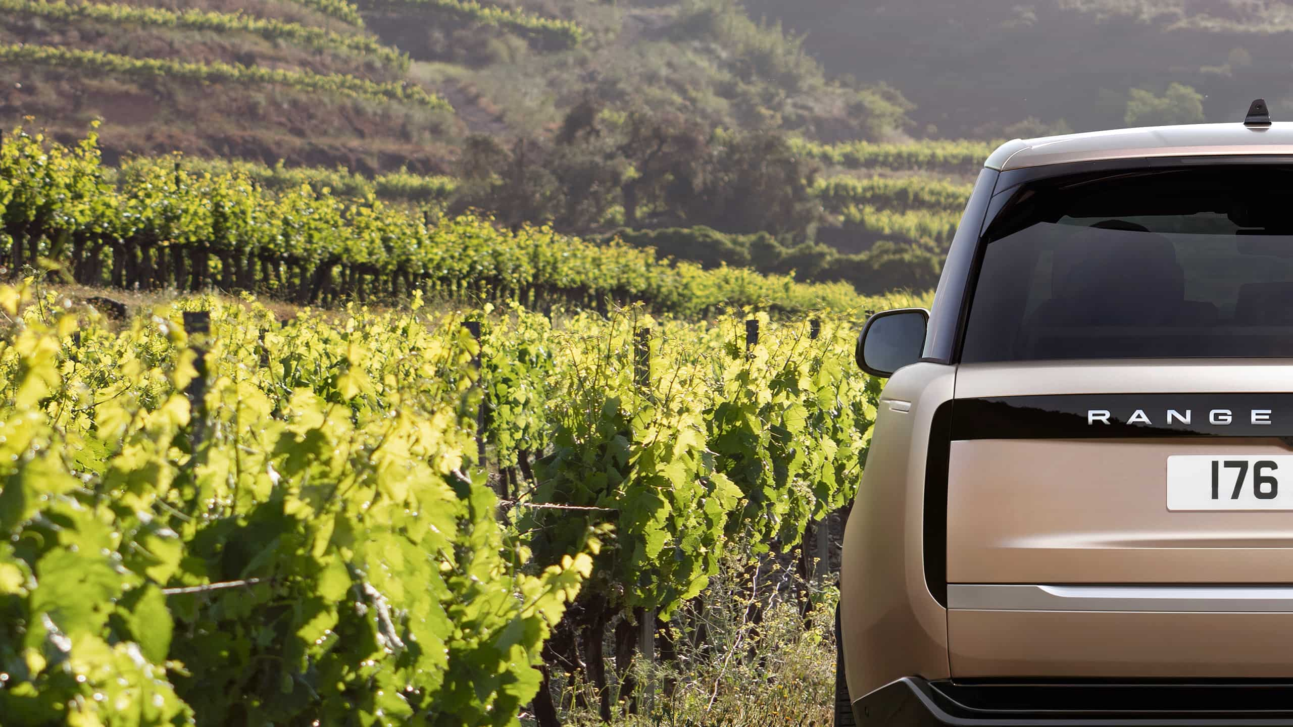 Rear view of Range Rover driving in Farm